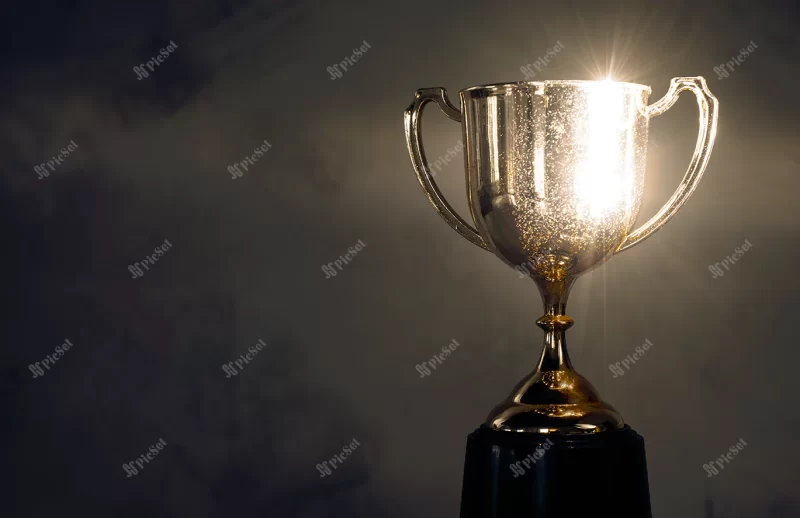 champion golden trophy placed wooden table / قهرمان جام طلایی روی میز چوبی