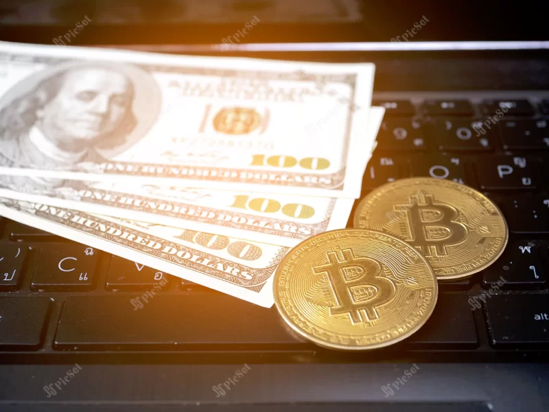 dollar money with bitcoin keyboard laptop top view / پول اسکناس دلار و  بیت کوین با صفحه کلید لپتاپ