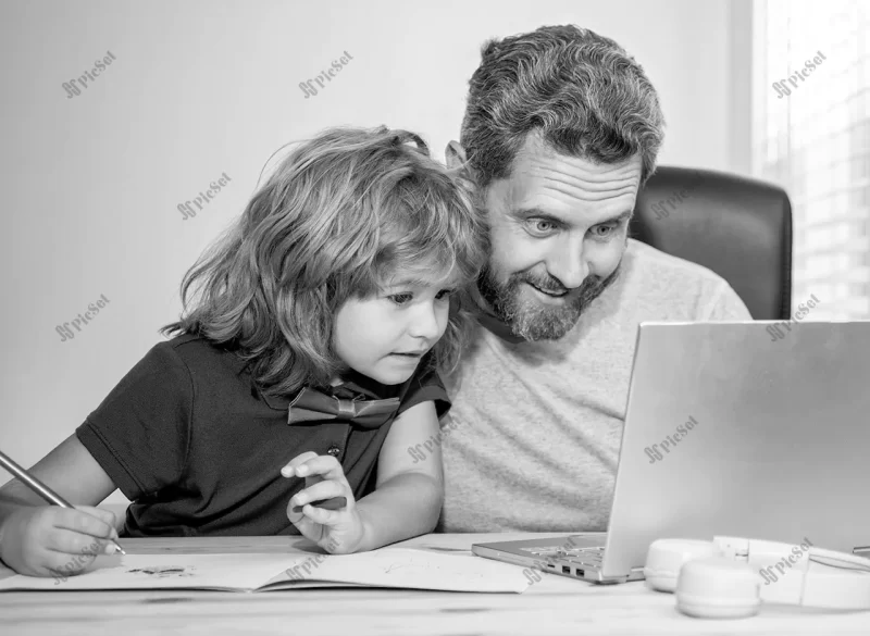 mature man teacher dad helping kid son with school homework computer check email / پدر معلم که به پسر بچه کمک می کند در انجام تکالیف مدرسه ایمیل را با رایانه چک کند