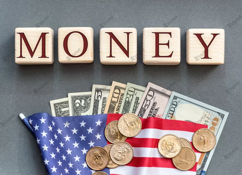 word money written by wooden cubes with american flag american dollar bills / مکعب های چوبی با پرچم آمریکا اسکناس های دلار آمریکا