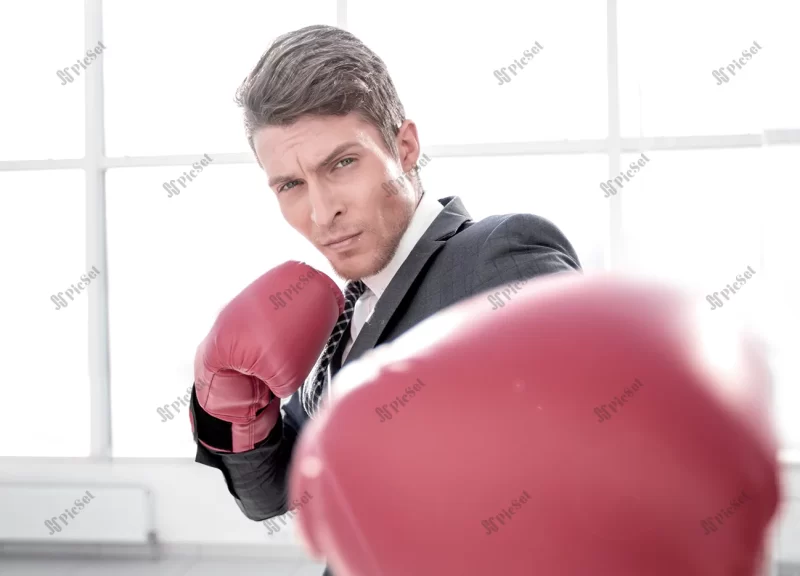 confident young businessman boxing gloves / تاجر جوان با اعتماد به نفس و دستکش بوکس